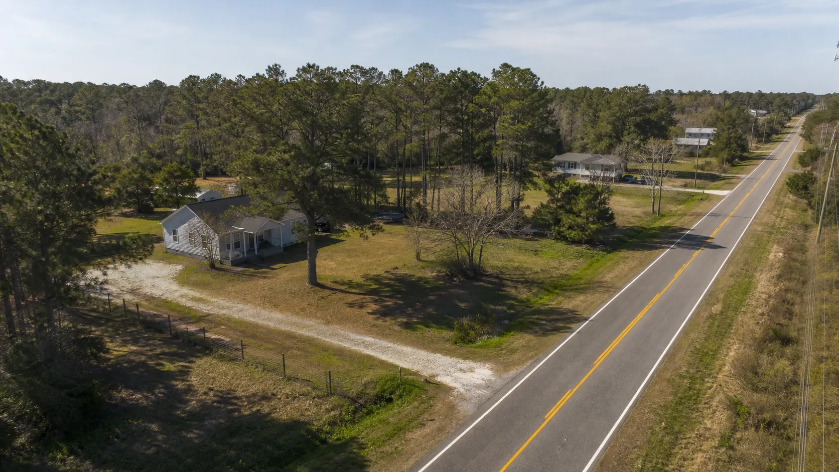 Rural road and homes scene representing Rocky Point, North Carolina.