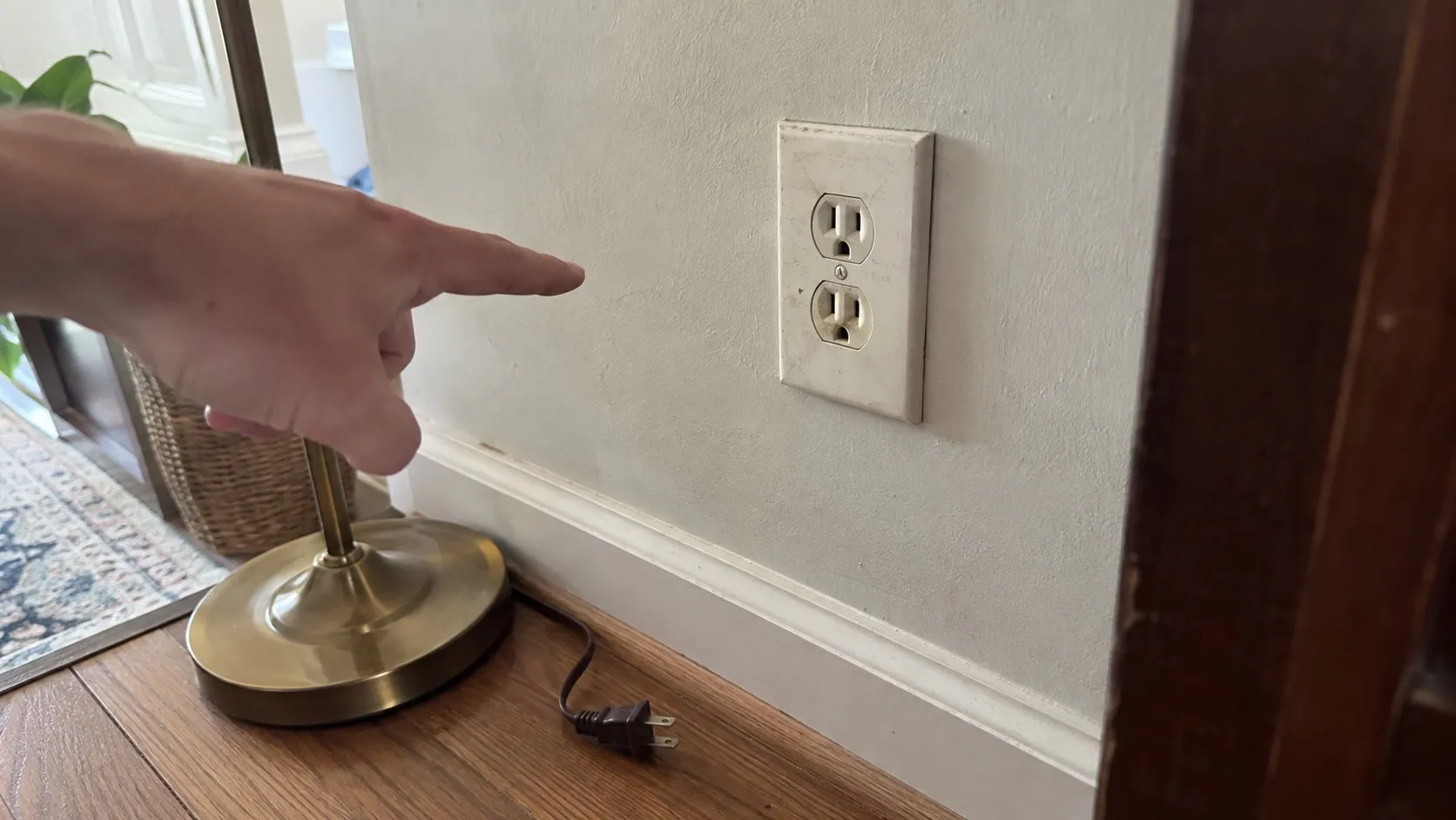 Is a Warm or Buzzing Outlet Dangerous? What to Do Next Intact residential outlet with homeowner nearby.